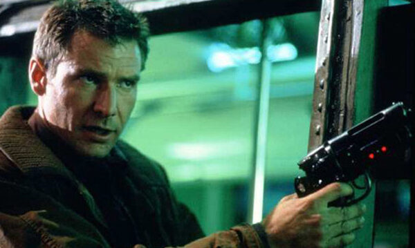 Harrison Ford points a gun in a still from 'Blade Runner' (1982).